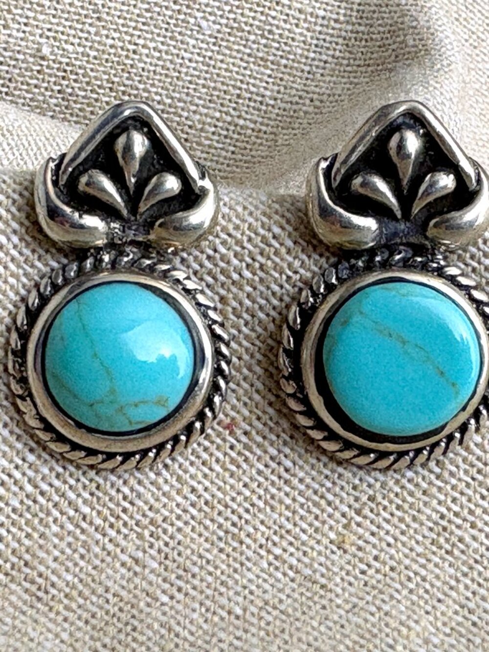 Southwest inspired sterling silver and turquoise drop earrings. The round stones